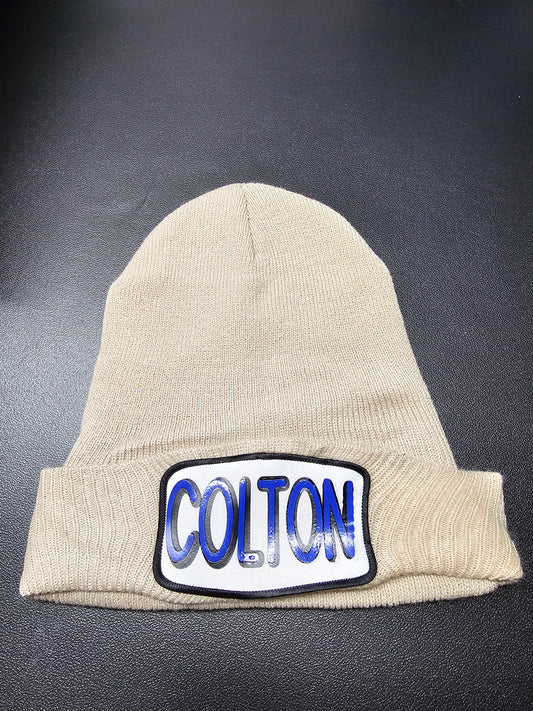 My personalized tan beanie with name on patch.