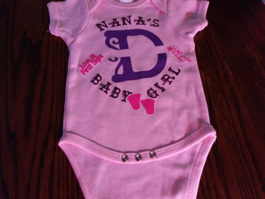 Personalized baby girl's Oneies with the letter D and name in the middle.