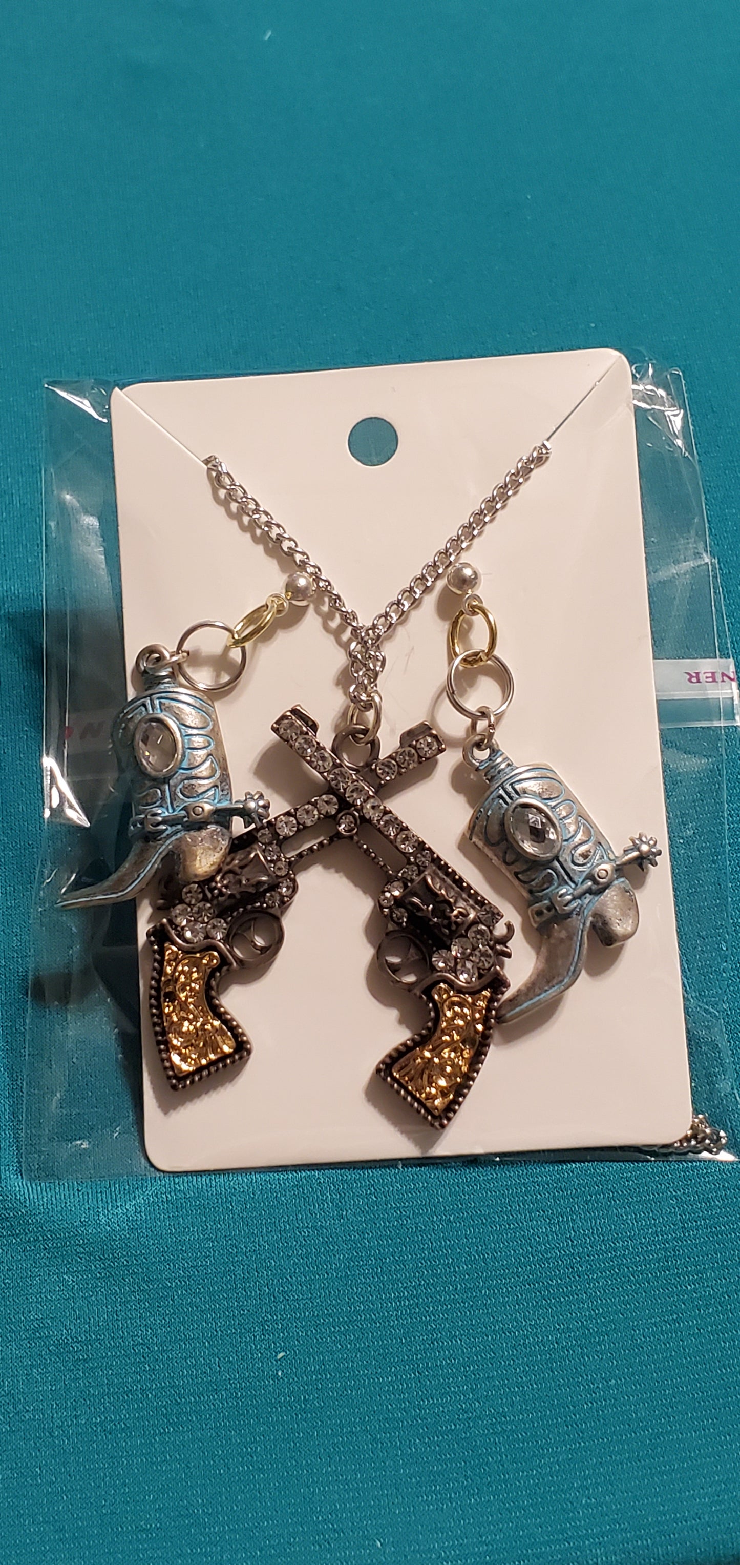 Cowgirl's guns and boots necklace and earrings