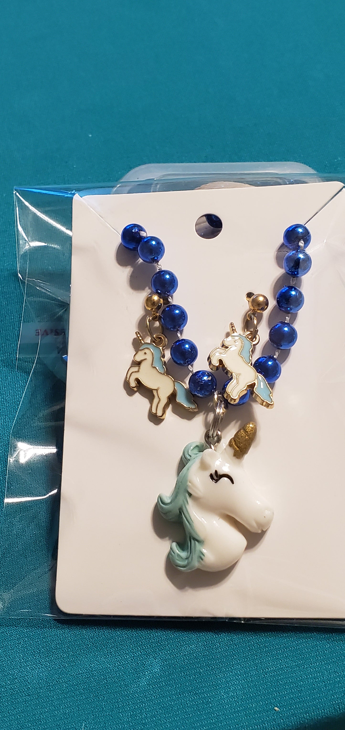 Blue &white Unicorn on blue beaded necklace